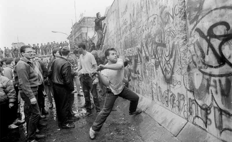 Crowds celebrating the fall of the Berlin Wall